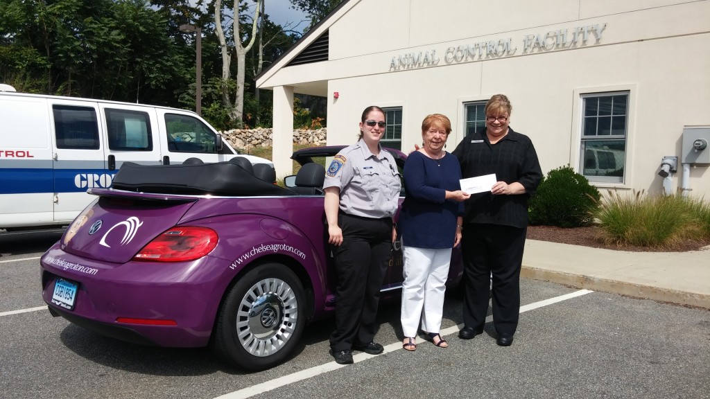 Standing next to the Chelsea Groton car are Animal Control Officer Christine O'Brien, GAF President Mary Kelly, and Karen Ventura, presenter of the check from Chelsea Bank.
